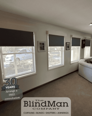 Dark grey roller blinds on windows