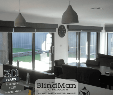 Grey roller blinds in dining room